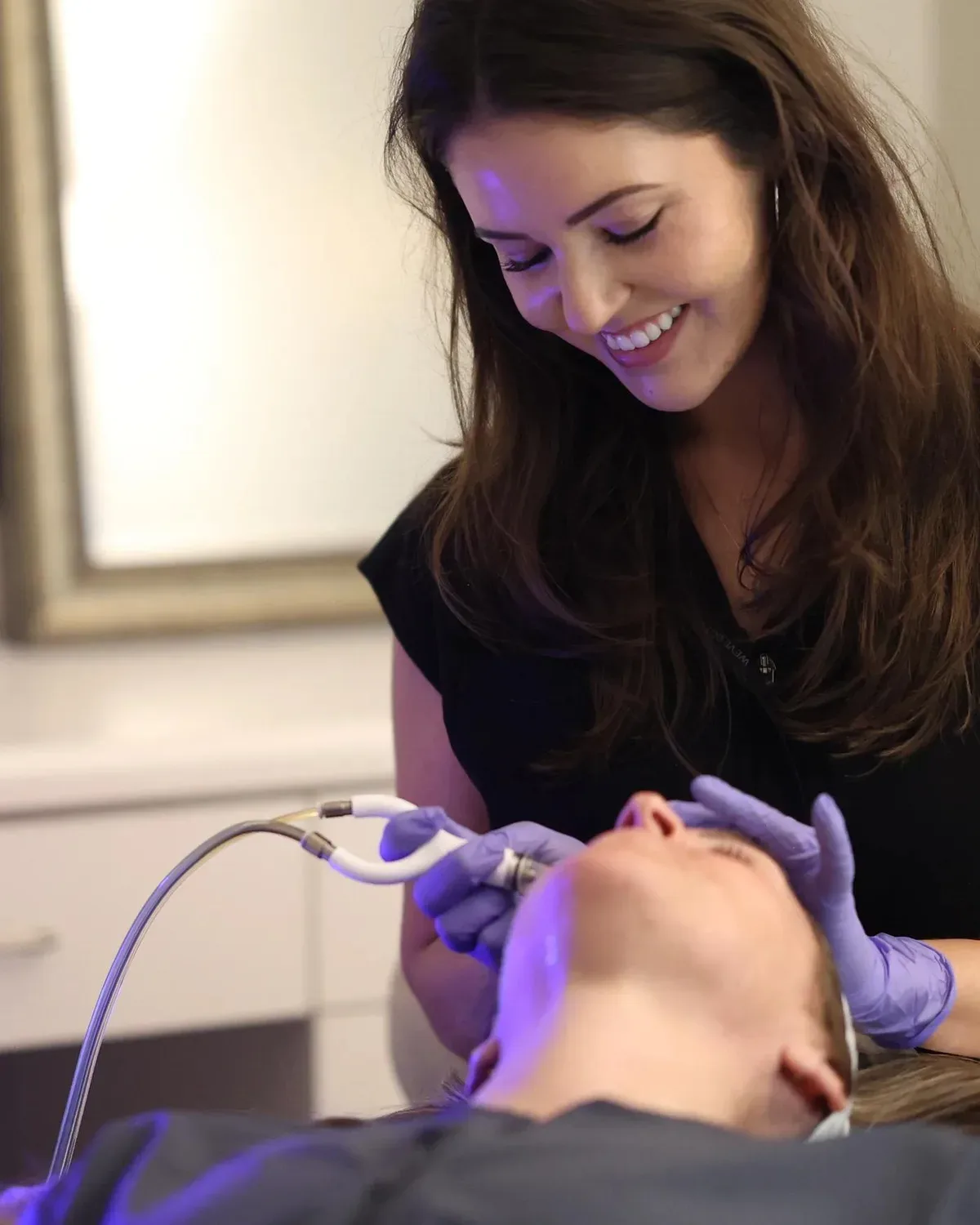 A Back to 30 provider performing a skin-resurfacing facial treatment